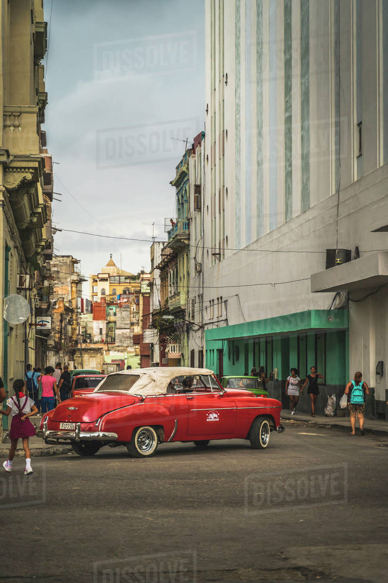 Red vintage car turning in streets of La Habana (Havana), Cuba, West Indies, Caribbean, Central America Royalty-free stock photo
