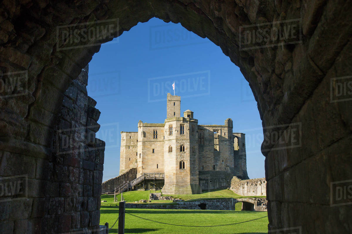 View through arch across lawns to the Great Tower of Warkworth Castle, Warkworth, Northumberland, England, United Kingdom, Europe Rights-managed stock photo