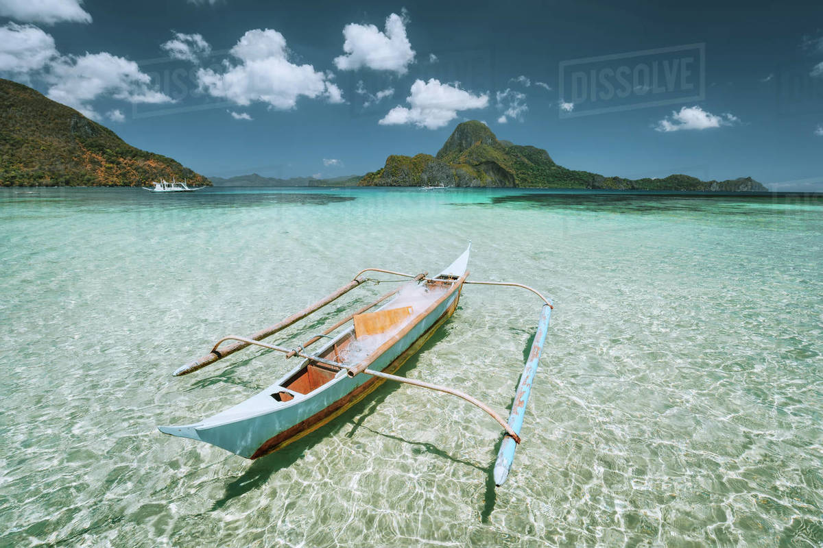 Palawan, Philippines. Traditional small fishing banca boat in front of