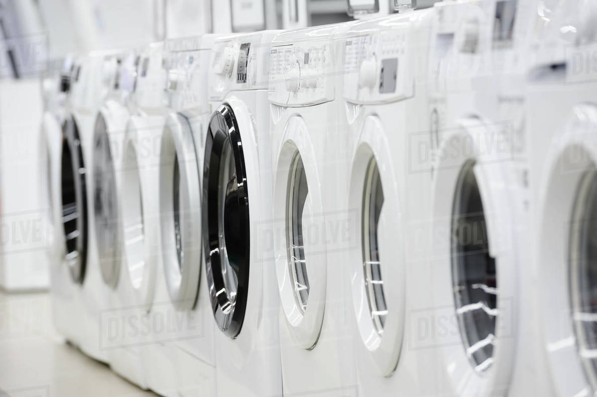 Row of washing machines in appliance store Stock Photo Dissolve