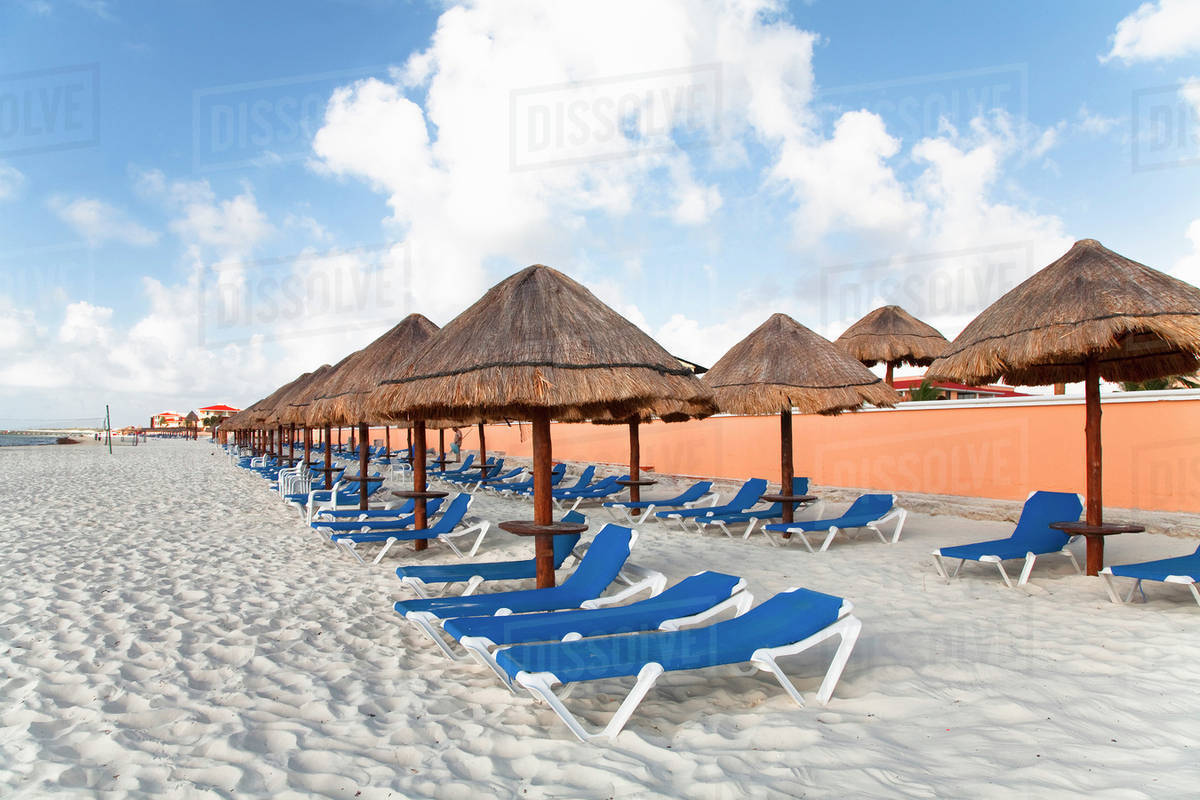 Playa Del Carmen, Cancun, Quintana Roo, Mexico Lounge chairs and shade umbrellas on a beach