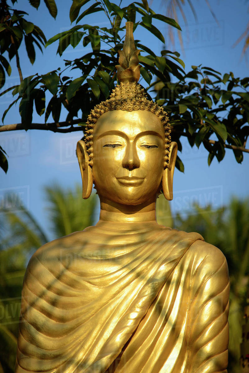 Laos, Luang Prabang. Buddha statue. Stock Photo Dissolve