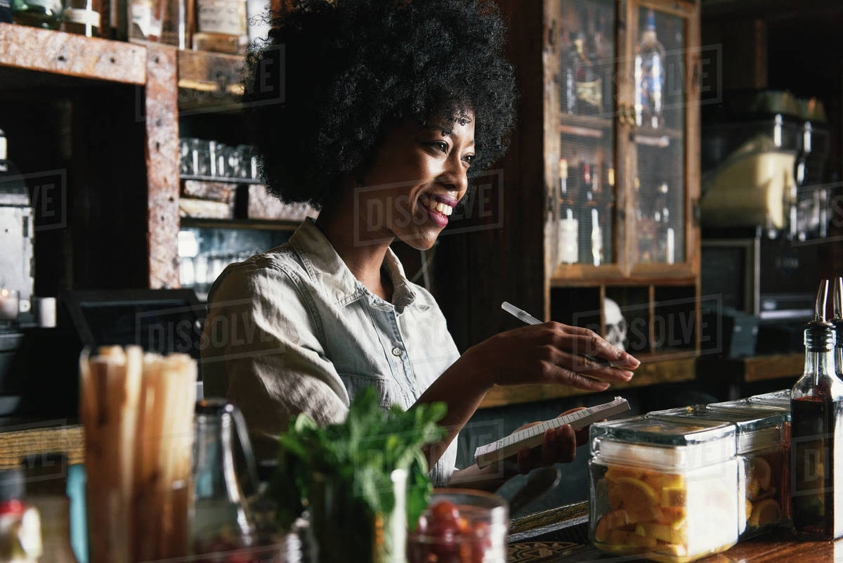 Bartender working behind bar in pub Stock Photo Dissolve