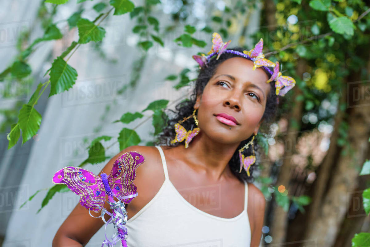 Portrait of mature woman wearing butterflies in her hair Royalty-free stock photo