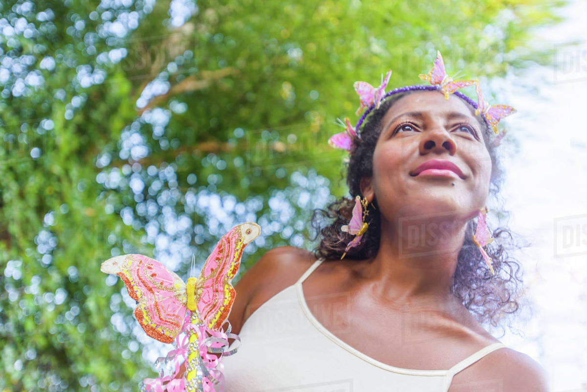 Portrait of mature woman dressed as fairy, outdoors Royalty-free stock photo