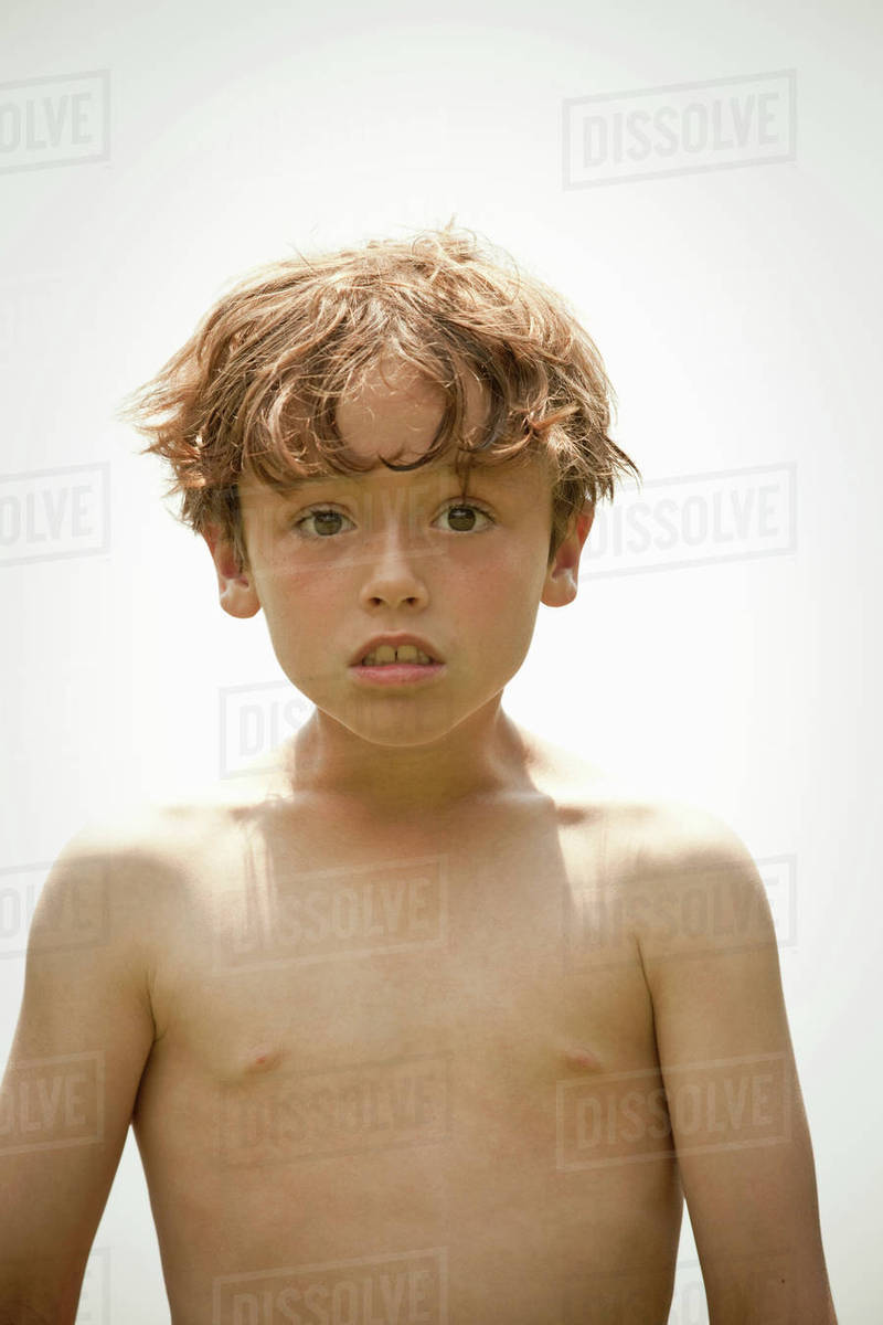 Barechested boy standing outdoors Stock Photo Dissolve