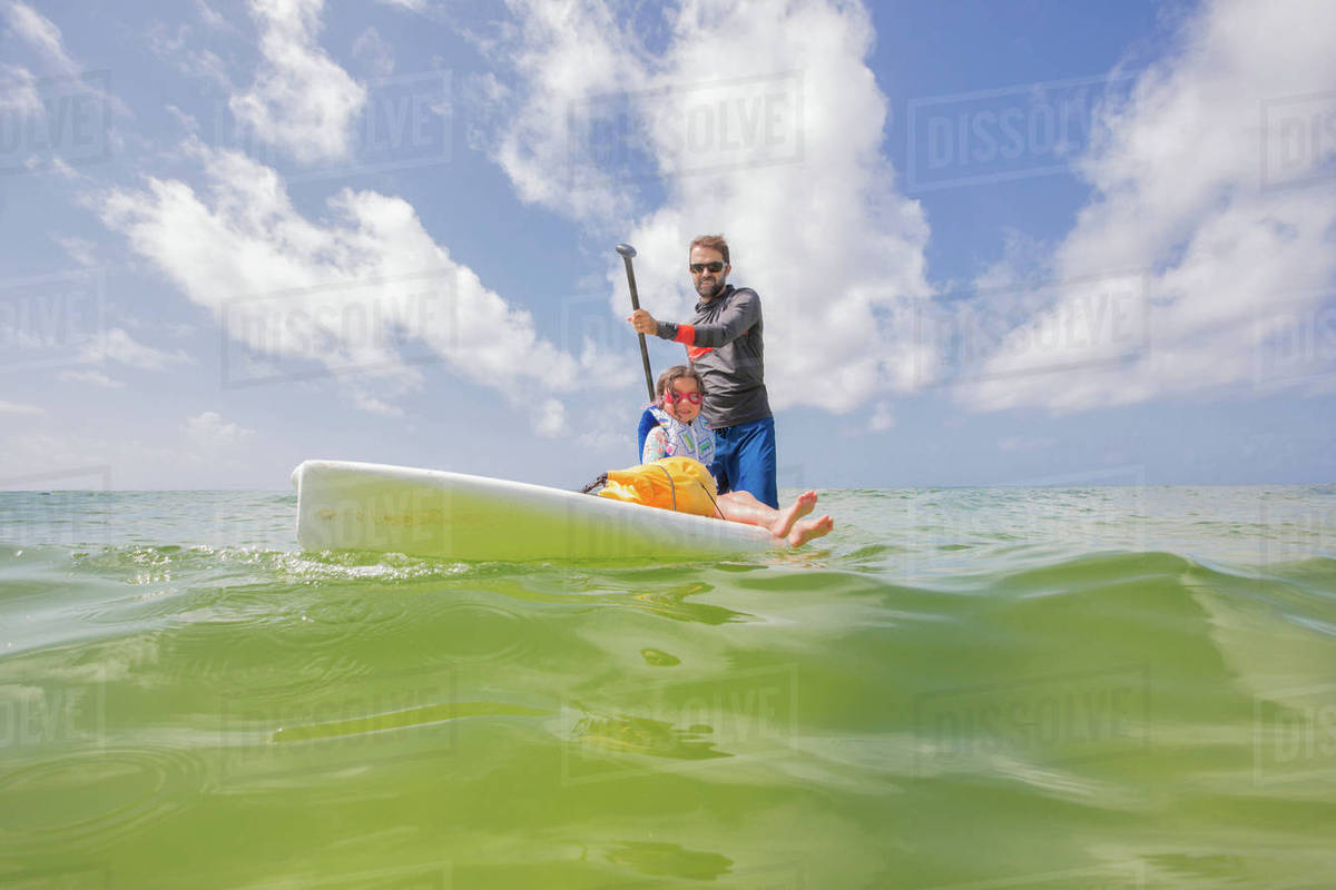 Father and daughter paddle boarding in the Gulf of Mexico, Destin