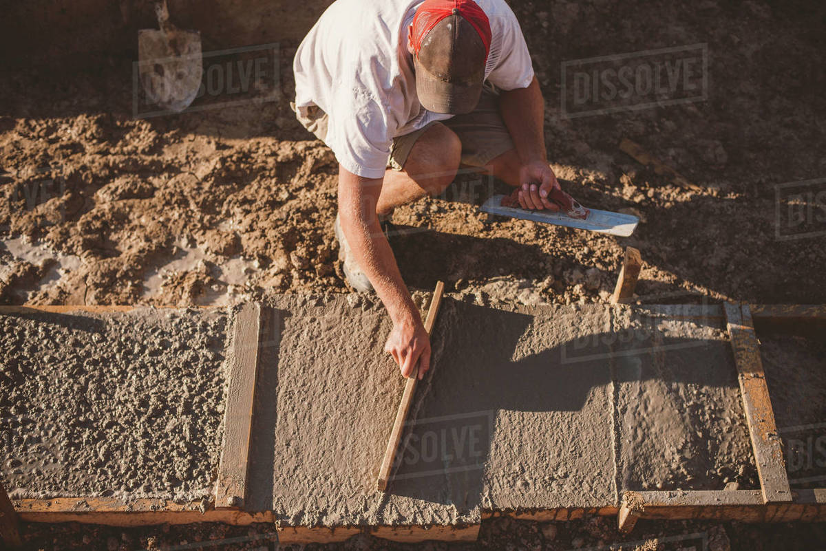 Builder laying cement foundation Stock Photo Dissolve