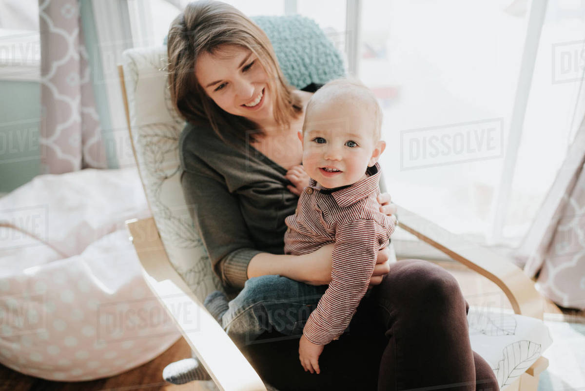 Baby boy sitting on mother's lap, portrait Royalty-free Stock