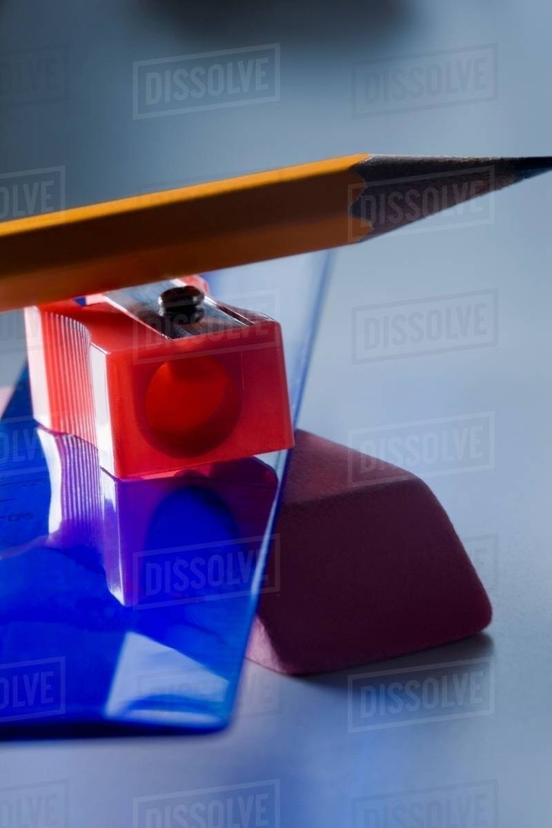Eraser, ruler, pencil sharpener and pencil in a pile Stock Photo