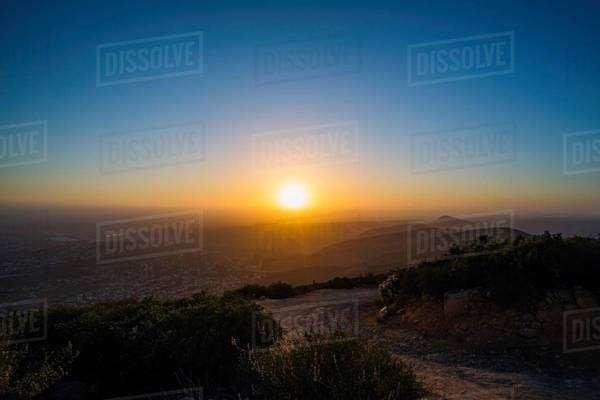 Sun rising over rural landscape - Stock Photo - Dissolve