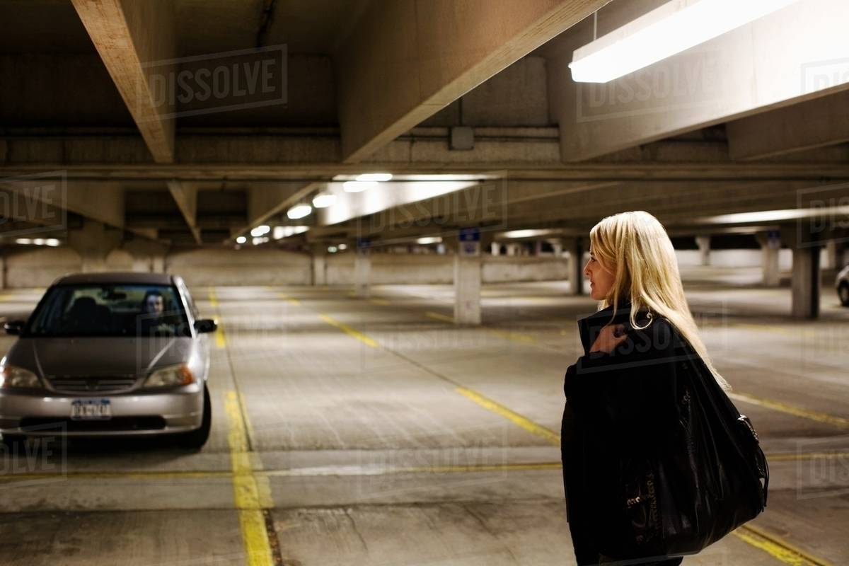 Woman in parking lot Stock Photo Dissolve
