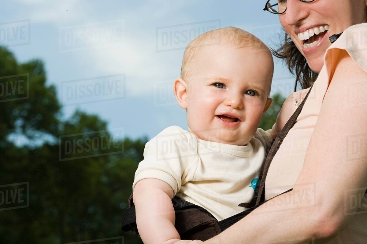 Mother carrying baby Stock Photo Dissolve