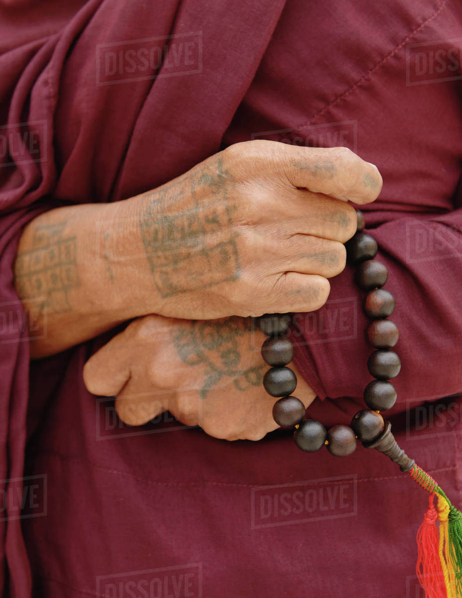 Close up of buddhist monk holding holy beads, Burma Stock Photo