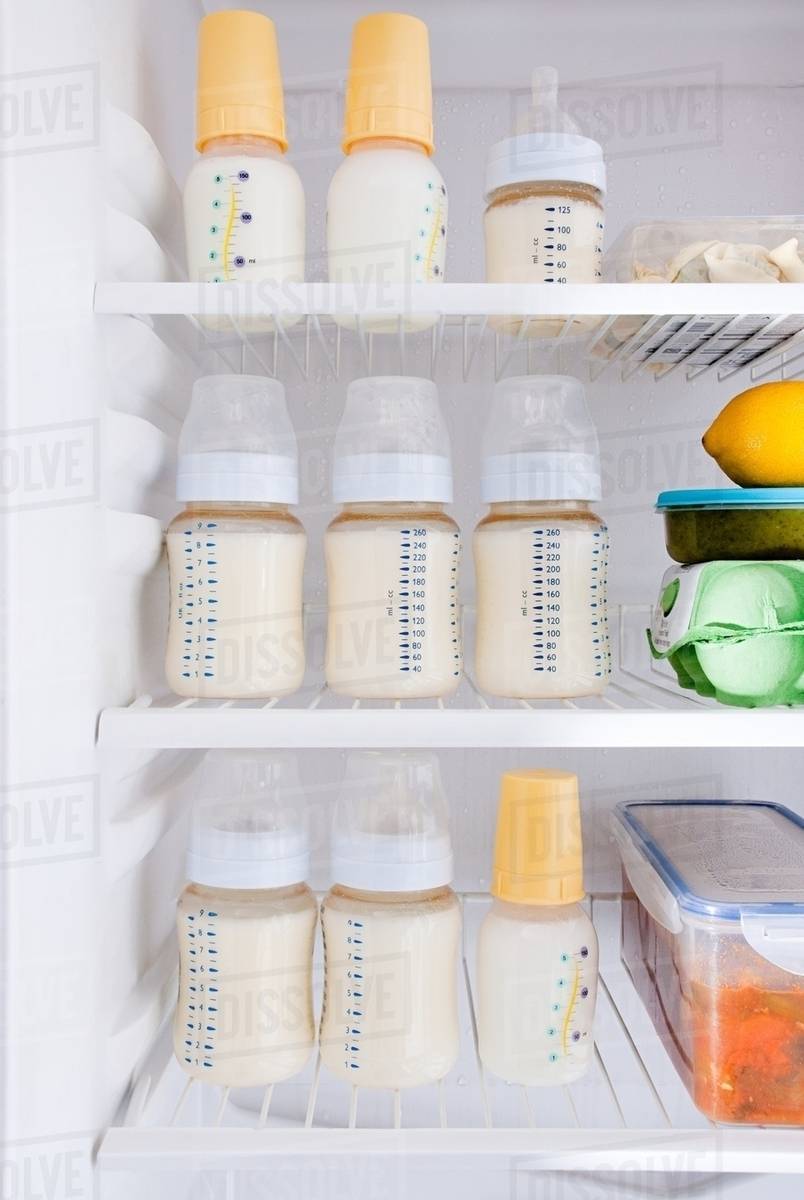 Bottles of breast milk in refrigerator Stock Photo Dissolve