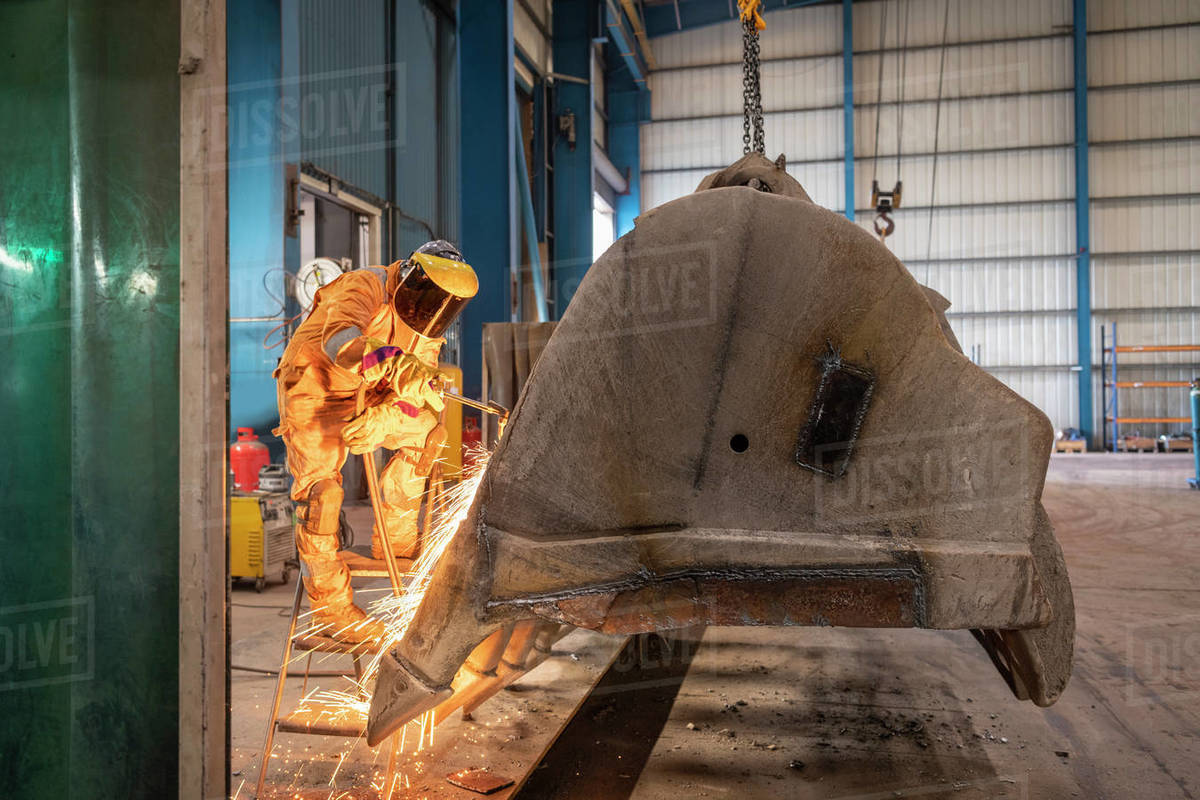 Man using acetylene burner in engineering factory Stock Photo Dissolve