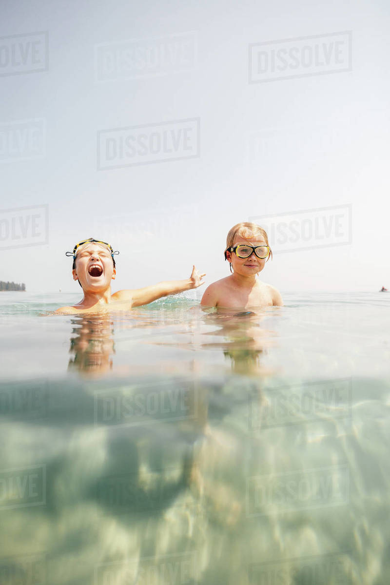 Boys (89) in swimming goggles in lake Stock Photo Dissolve