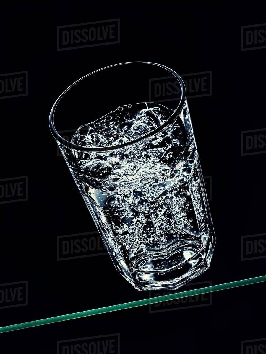 Glass of sparkling water Stock Photo Dissolve