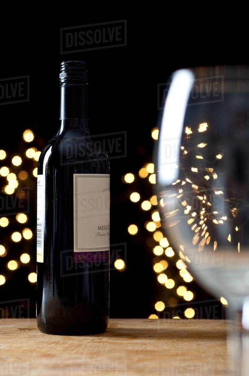 Bottle of red wine and empty glass Stock Photo Dissolve