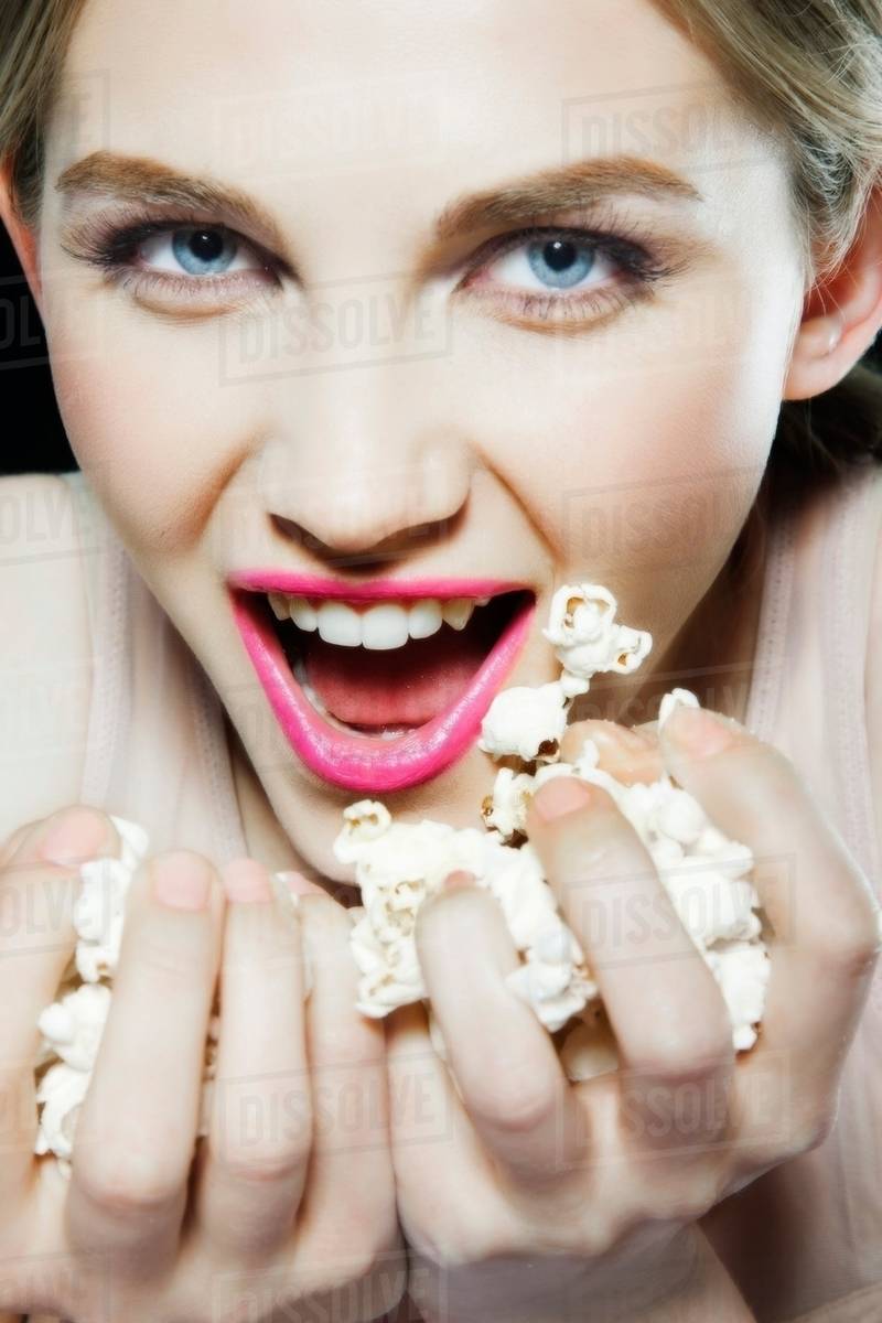 Woman eating popcorn Stock Photo Dissolve