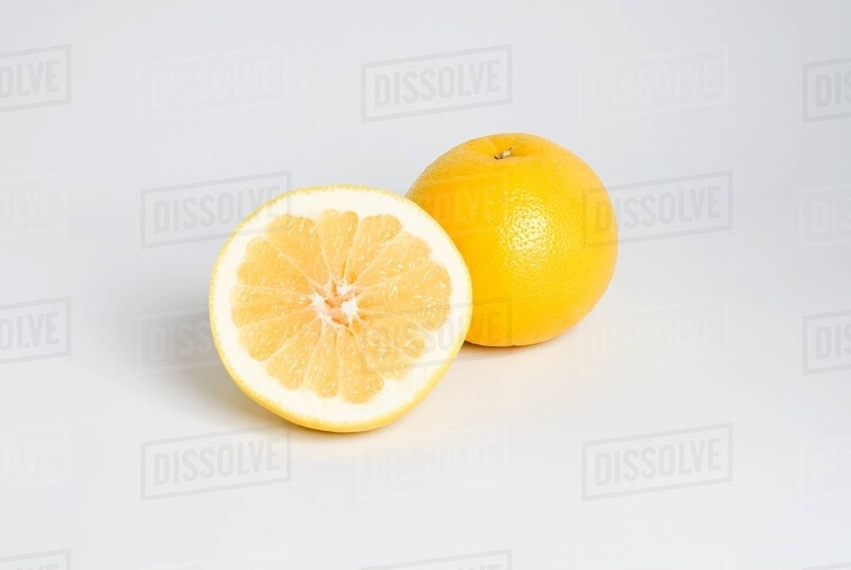 Whole and half grapefruit Stock Photo Dissolve