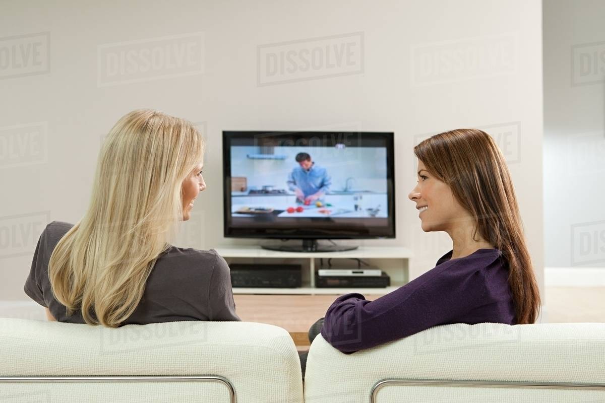 Two young women watching television - Stock Photo - Dissolve - How To Watch What Is A Woman On Tv