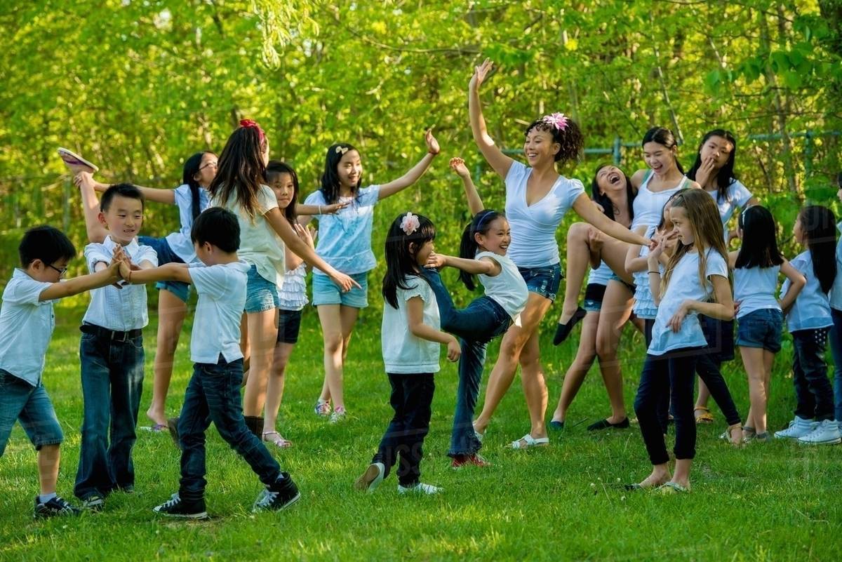 Large group of children dancing in park Stock Photo Dissolve