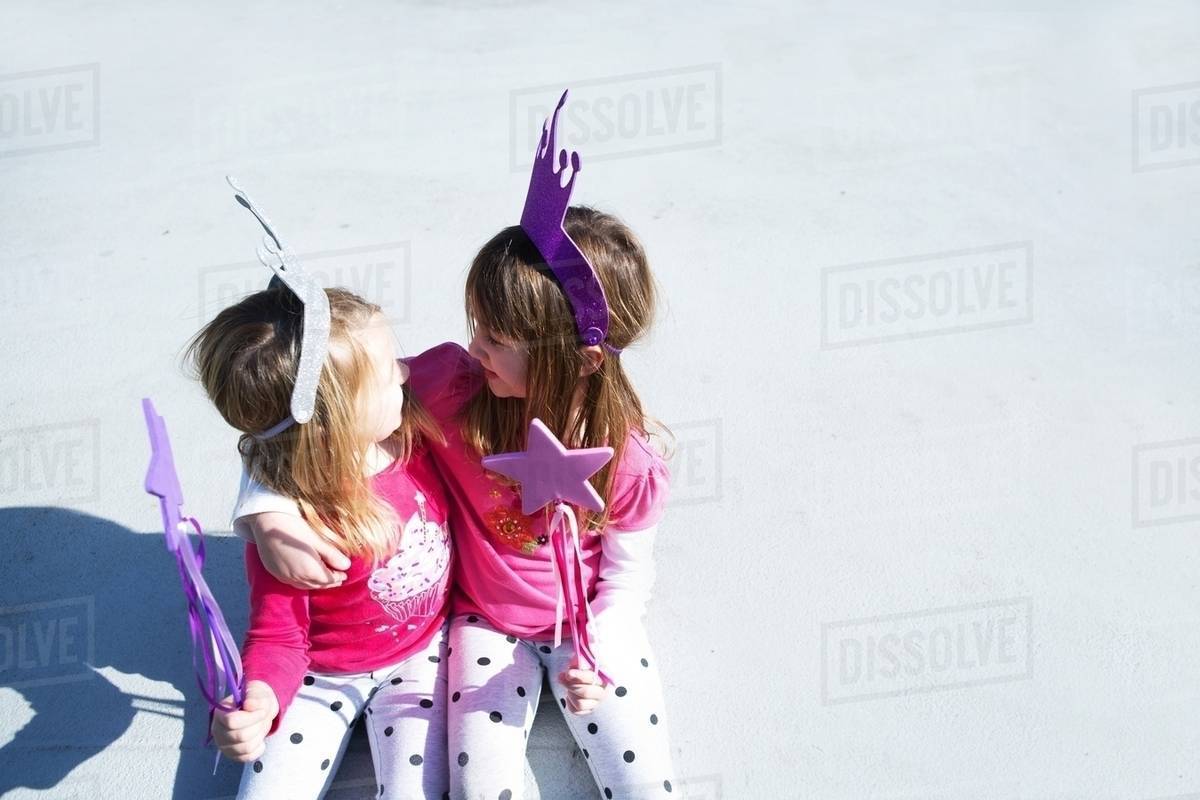 Two young sisters dressed up as fairies holding wands Royalty-free stock photo