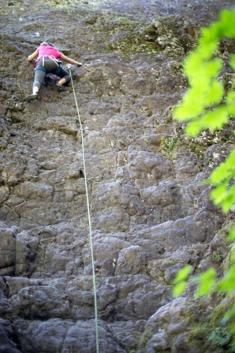 Woman rock climbing, French's Dome, Zig Zag, Oregon, USA Stock Photo