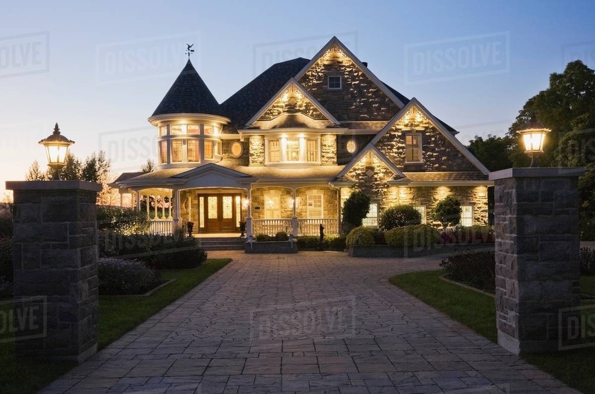 Elegant Grey Stone House With White Trim And Blue Roof At Dusk In Elegant Grey Stone House With White Trim And Blue Roof At Dusk In Summer Quebec Canada