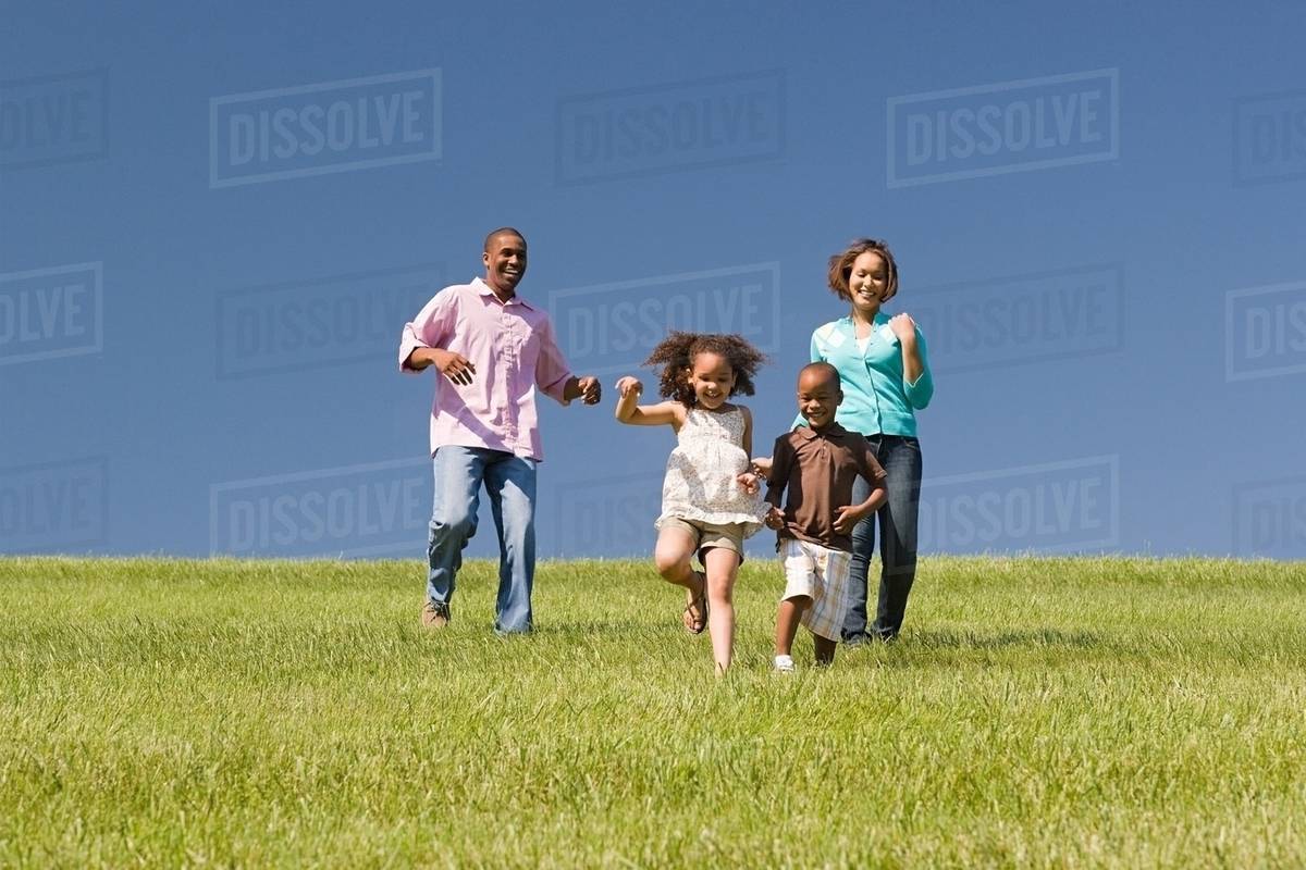Family in a field - Stock Photo - Dissolve