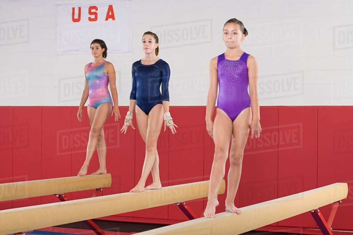 Gymnasts on a balance beam Stock Photo Dissolve