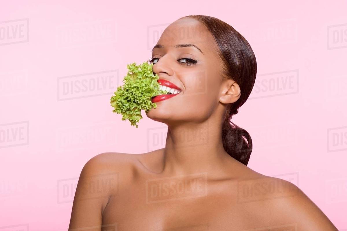 Woman eating lettuce Stock Photo Dissolve