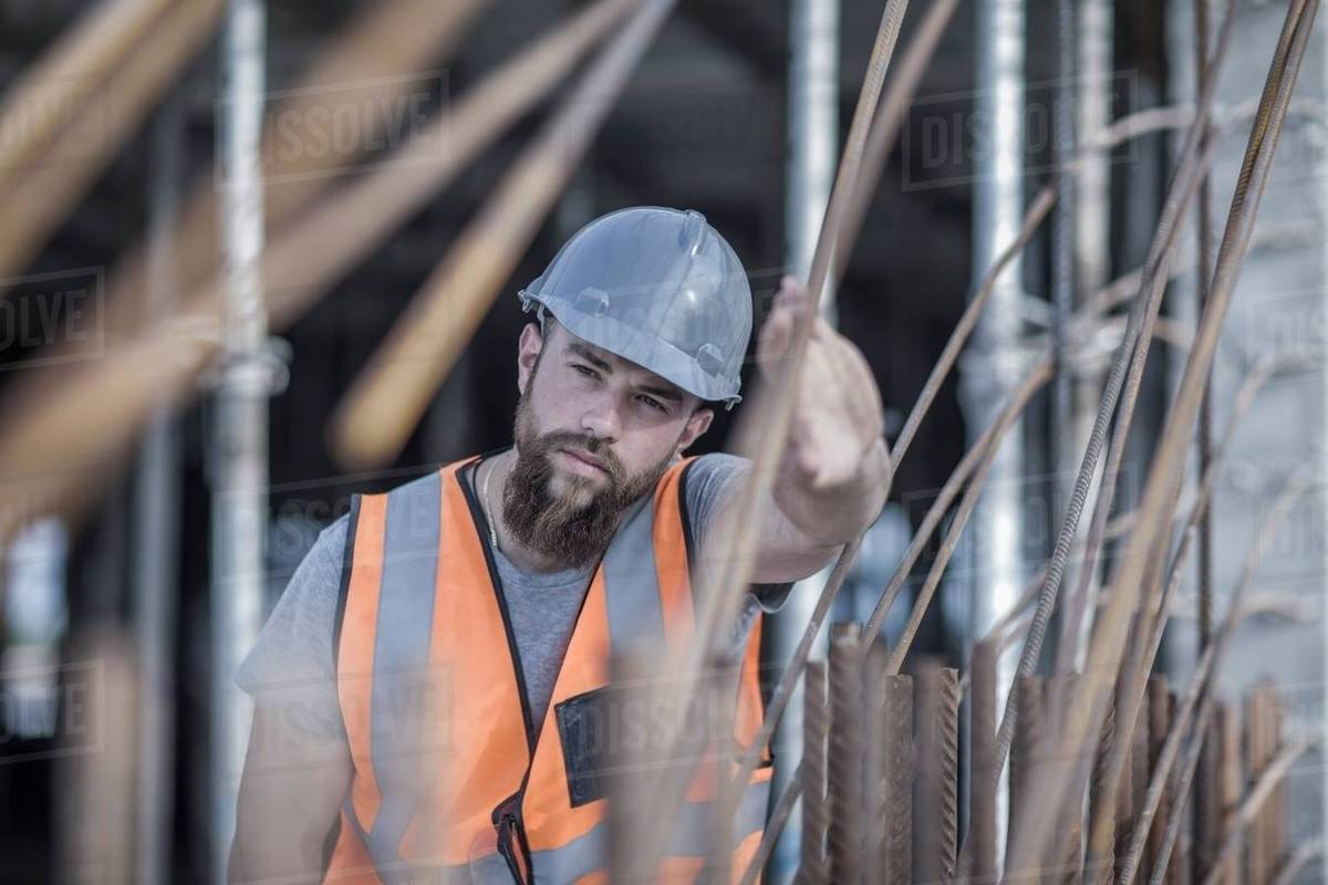 Site manager signaling with hand on construction site Stock Photo Dissolve