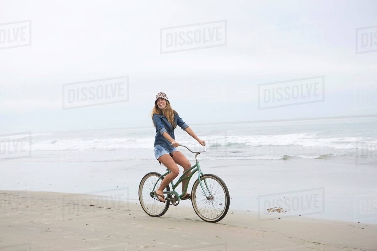 Woman Riding Bicycle On Beach Stock Photo Dissolve Woman Riding Bicycle On Beach