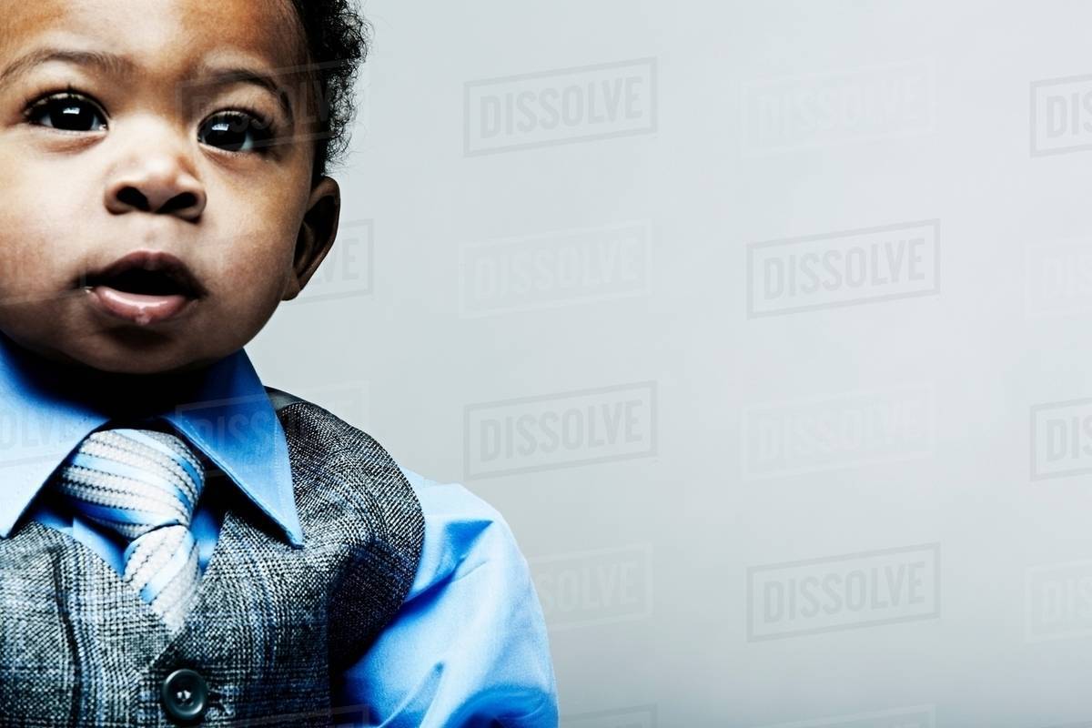 Portrait of baby boy wearing waistcoat, shirt and tie Stock Photo Dissolve