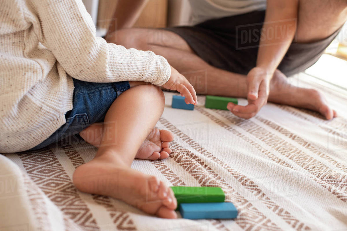 Little kid and his father playing at home with wood building blocks. Homeschooling. Stay at home. Family time Royalty-free stock photo