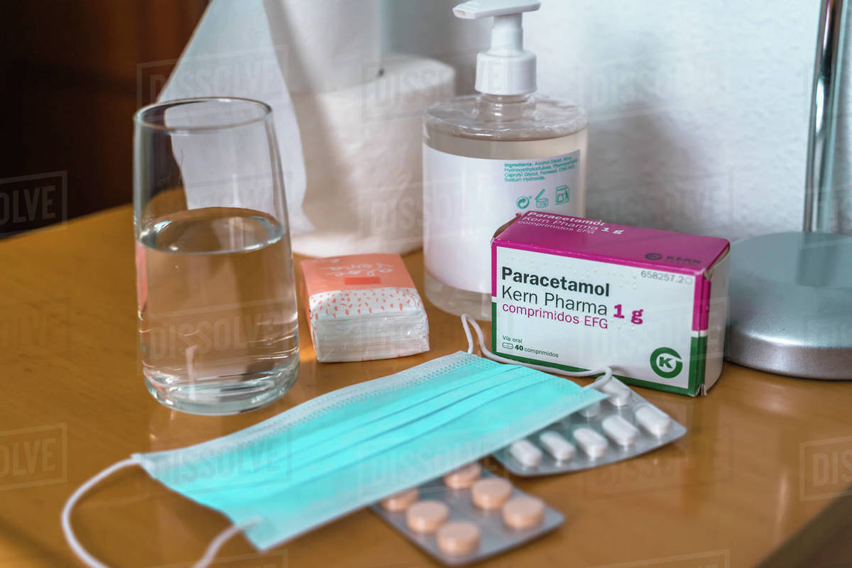 Paracetamol pills, glass of water, Sanitizing Gel, tissues and medical