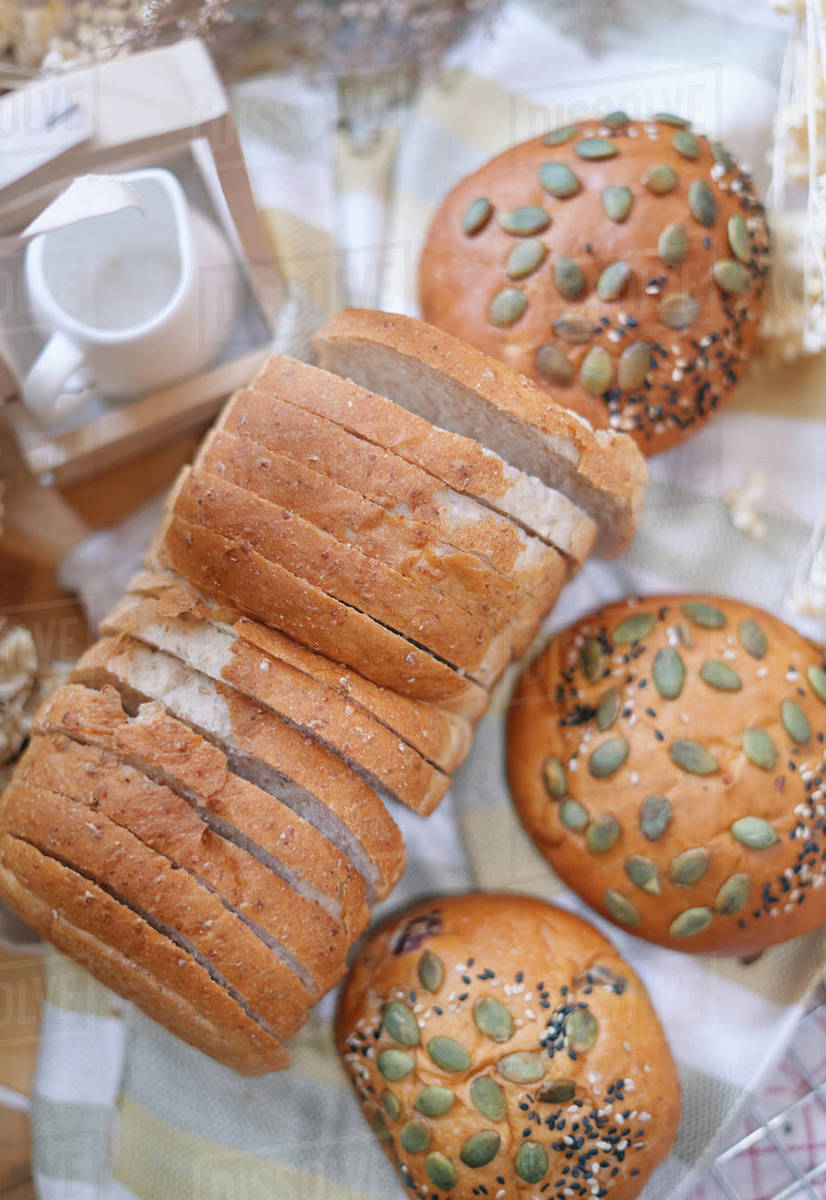 Whole grains buns and sliced whole wheat bread Stock Photo Dissolve