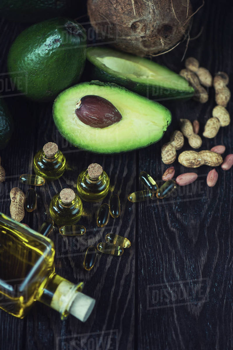 Oil of avocado with fish oil pills and peanut source of omega 3 on a