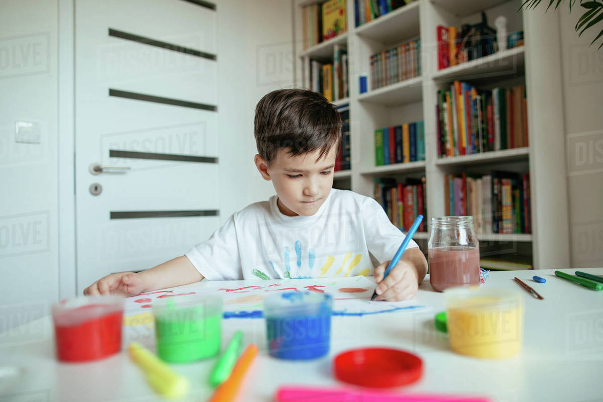 5-year-old-preschooler-boy-drawing-on-his-painting-with-left-hand