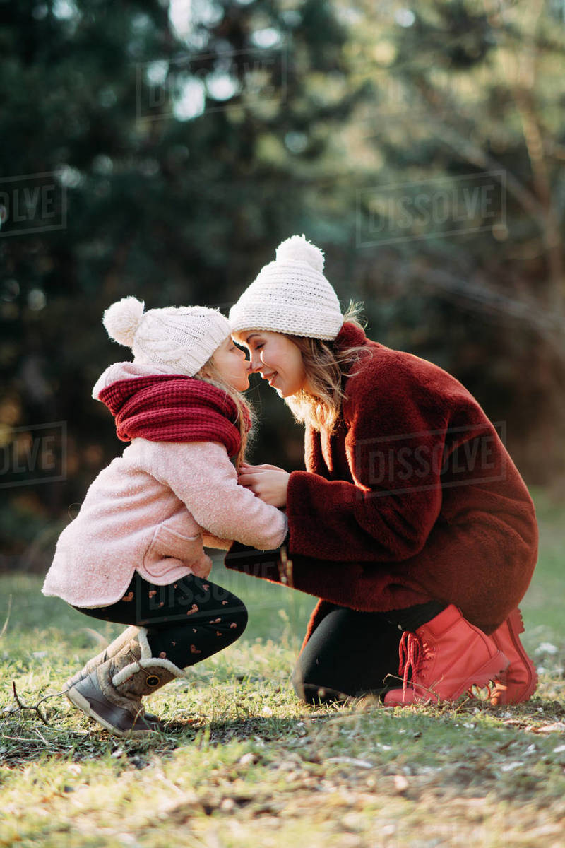 Mother and daughter play and have fun while walking in the forest. Royalty-free stock photo