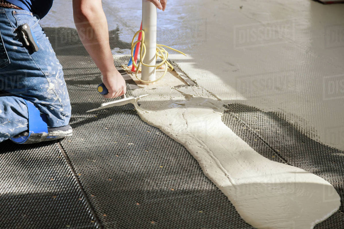 Preparation before pouring concrete in troweling adhesive onto floor a