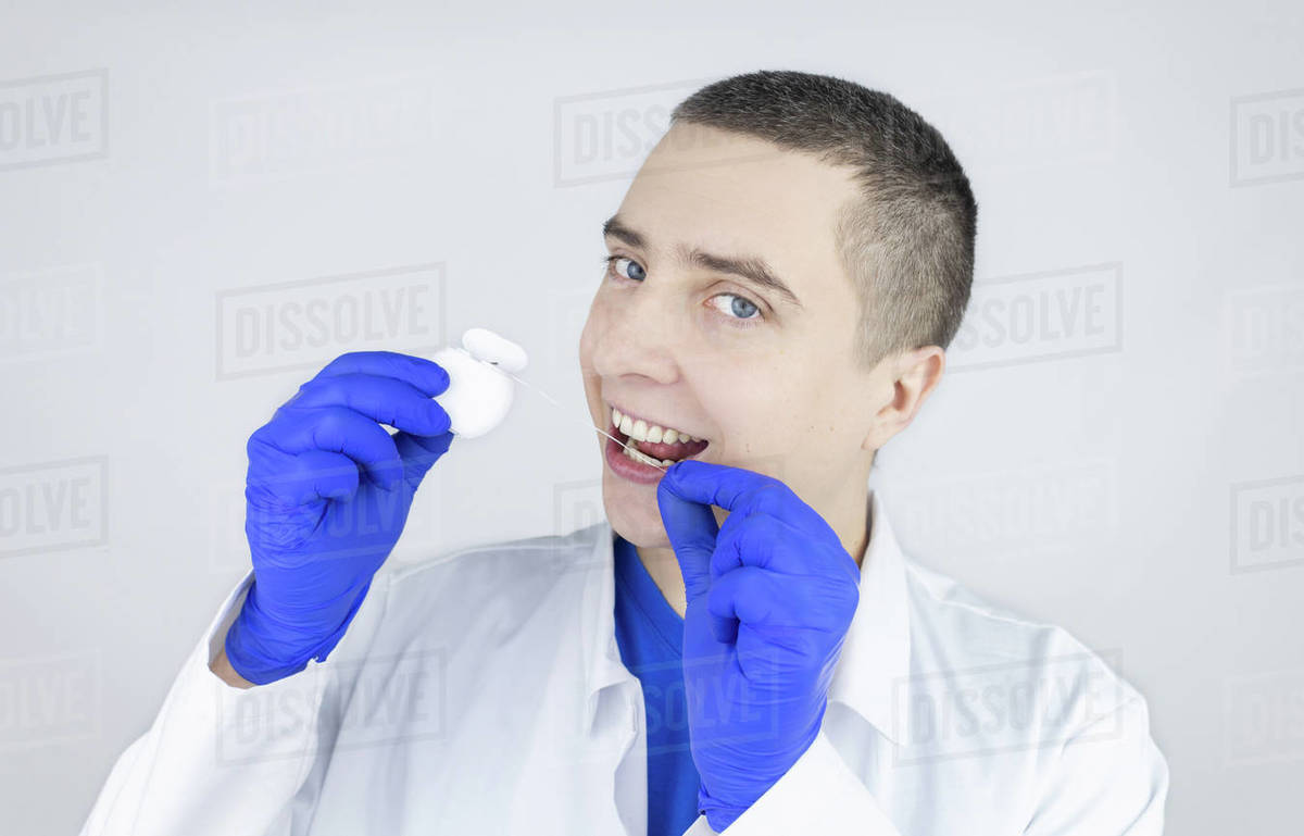 Dental floss close up. Dentist shows how to use the thread correctly