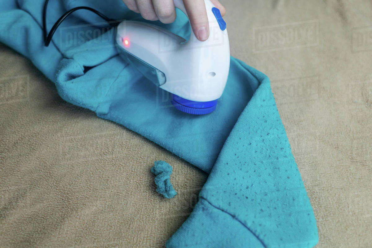 Machine for removing pellets. The girl uses a special device to remove