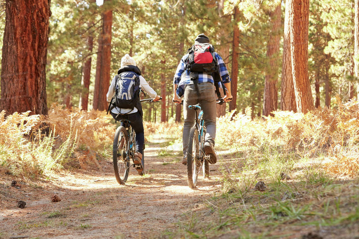 African American Couple Cycling Through Fall Woodland Royalty-free stock photo