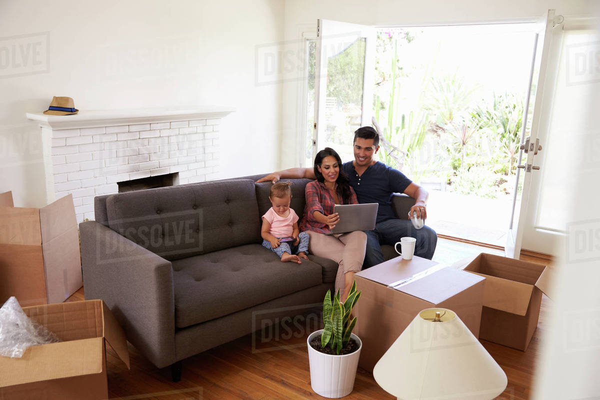 Family Take A Break On Sofa Using Laptop Moving Day Stock Photo Family Take A Break On Sofa Using Laptop Moving Day