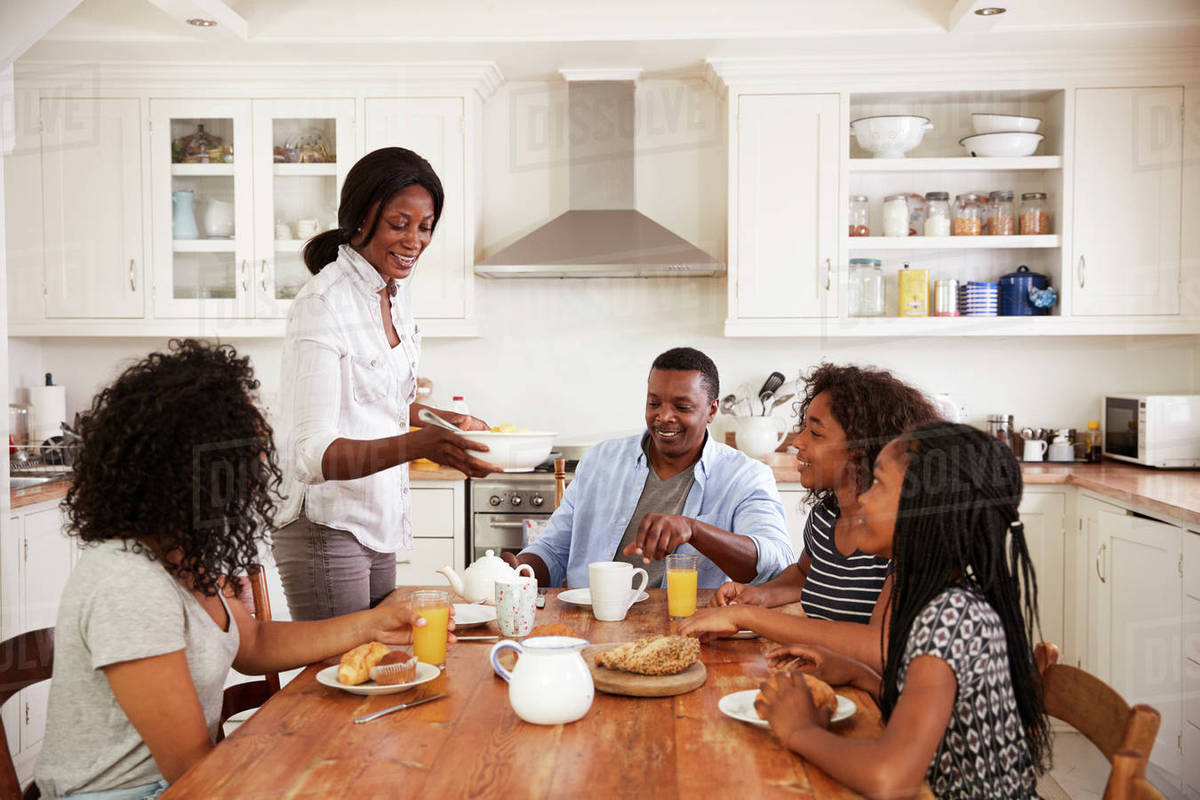 Family With Teenage Children Eating Breakfast In Kitchen Stock Photo Dissolve