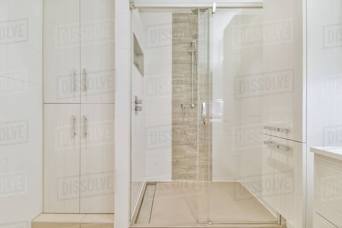 Large shower cubicle with glass railing in a luxurious bathroom Stock