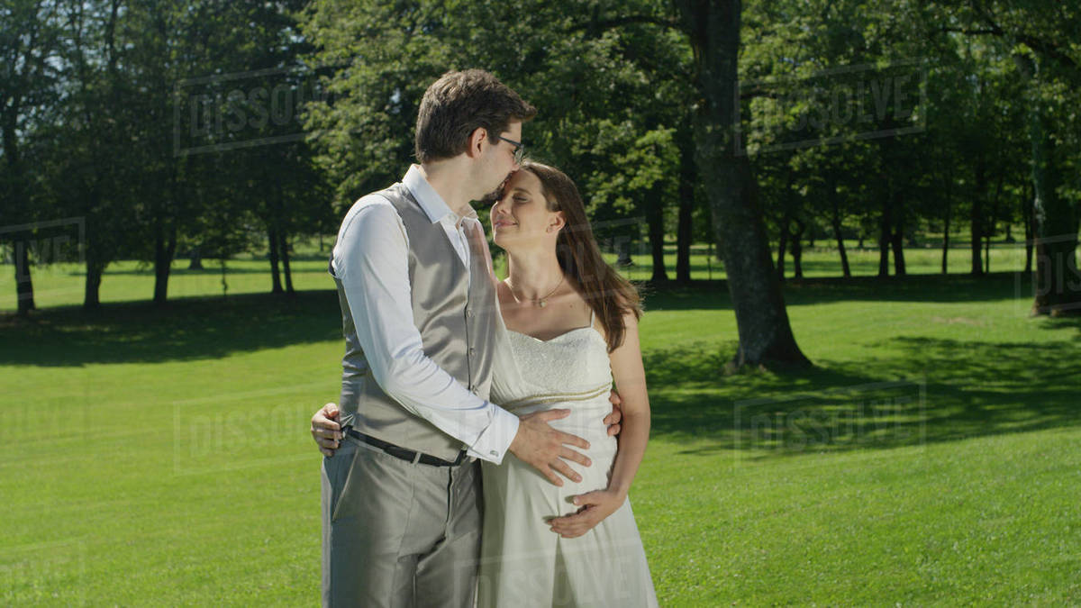 caressing her pregnant belly